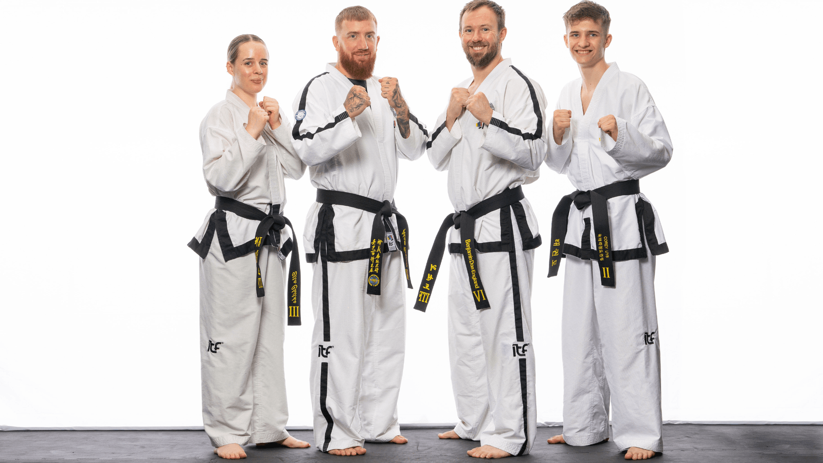 Four black-belt instructors at Apex in traditional Taekwon-Do gi.